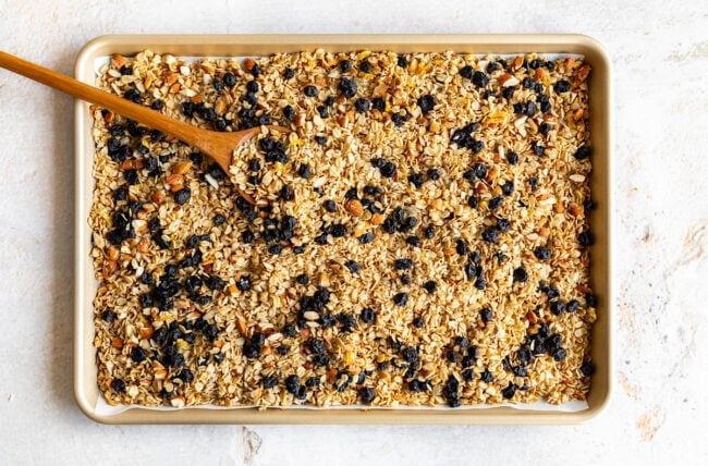 lemon blueberry granola cooling on baking sheet.