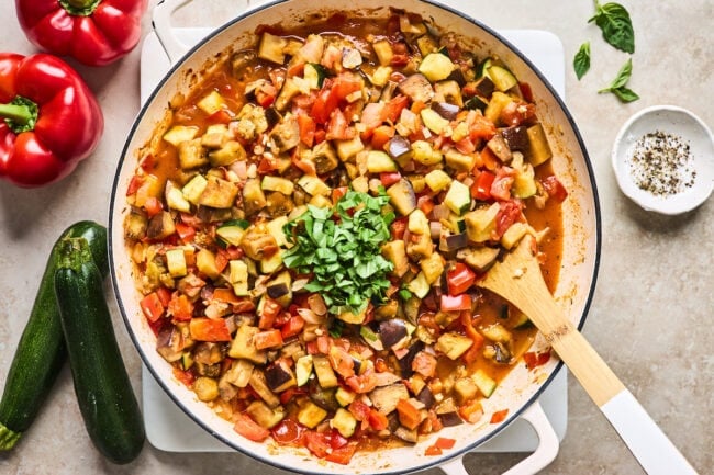 ratatouille in skillet with wooden spoon.