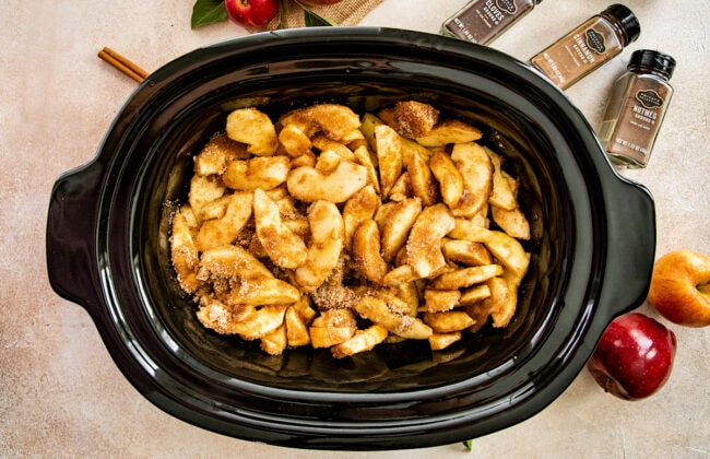 apple butter ingredients in a slow cooker. 