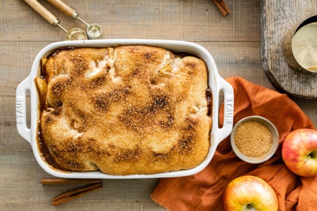 apple cobbler in pan with cinnamon sugar topping. 