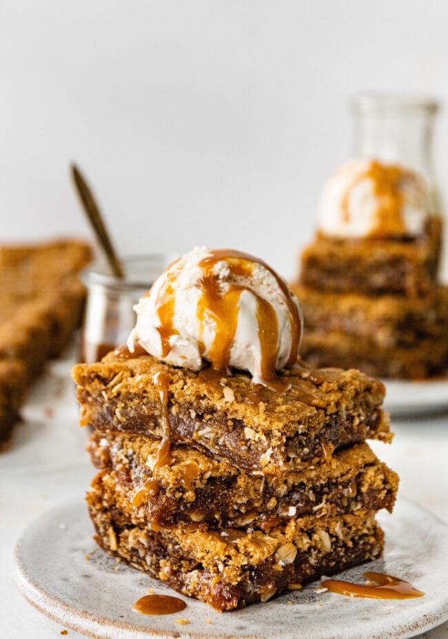 stack of Biscoff caramel cookie bars with ice cream and caramel sauce