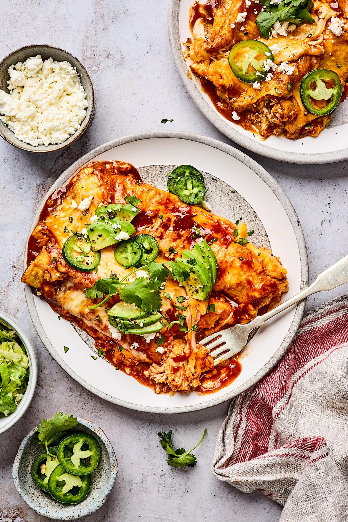 chicken enchiladas on plate with fork. 