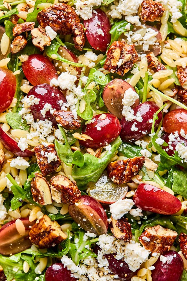 orzo salad with grapes, arugula, feta cheese, and candied pecans.
