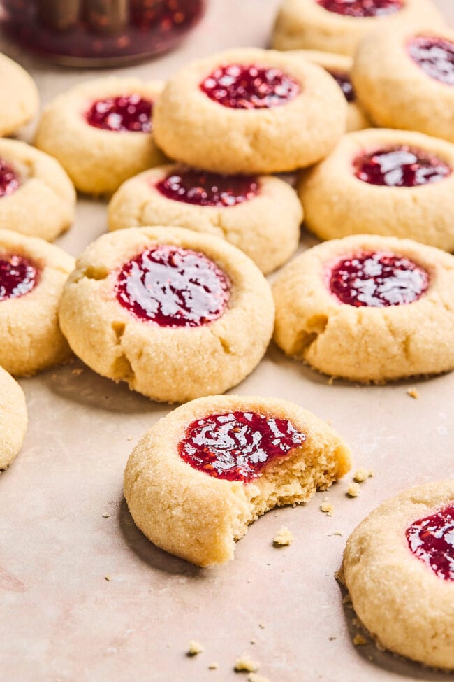 jam thumbprint cookies with one half eaten. 