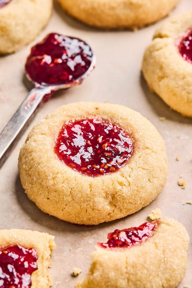thumbprint cookie with raspberry jam on a spoon. 
