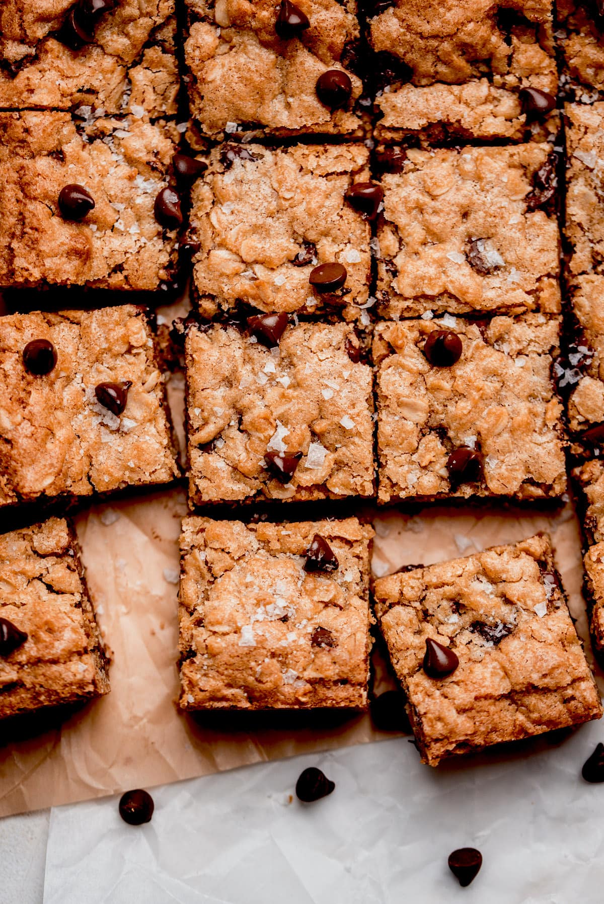 oatmeal chocolate chip bars cut into squares on parchment paper. 