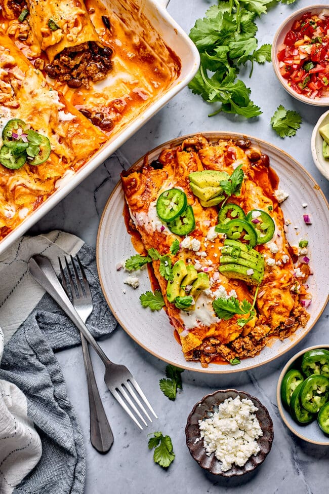 beef enchiladas on plate with two forks
