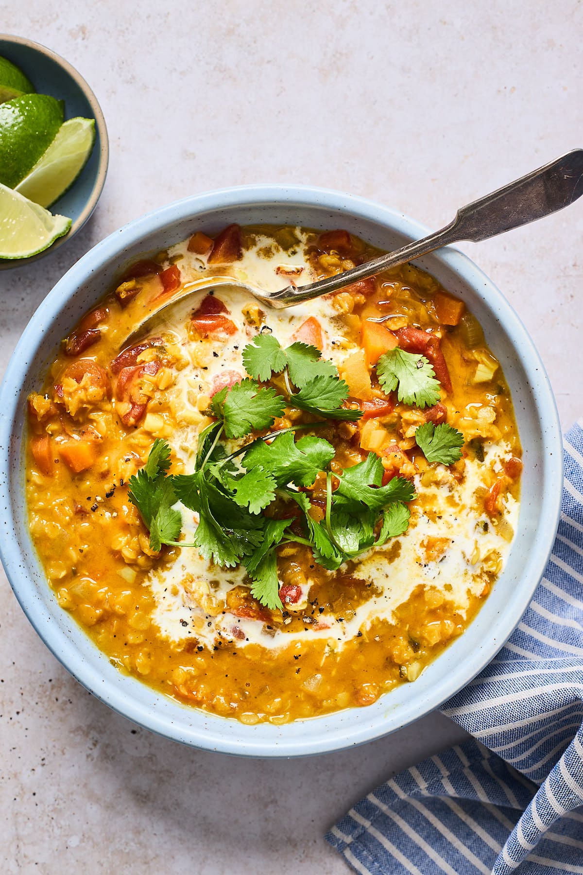 curry lentil soup in bowl with cilantro and coconut milk.