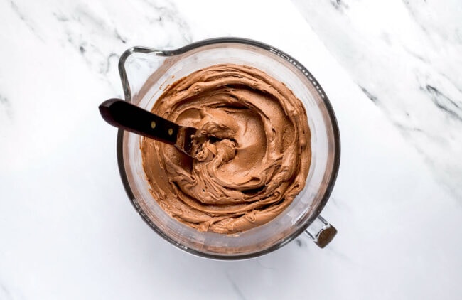 chocolate buttercream frosting in a bowl for yellow cake