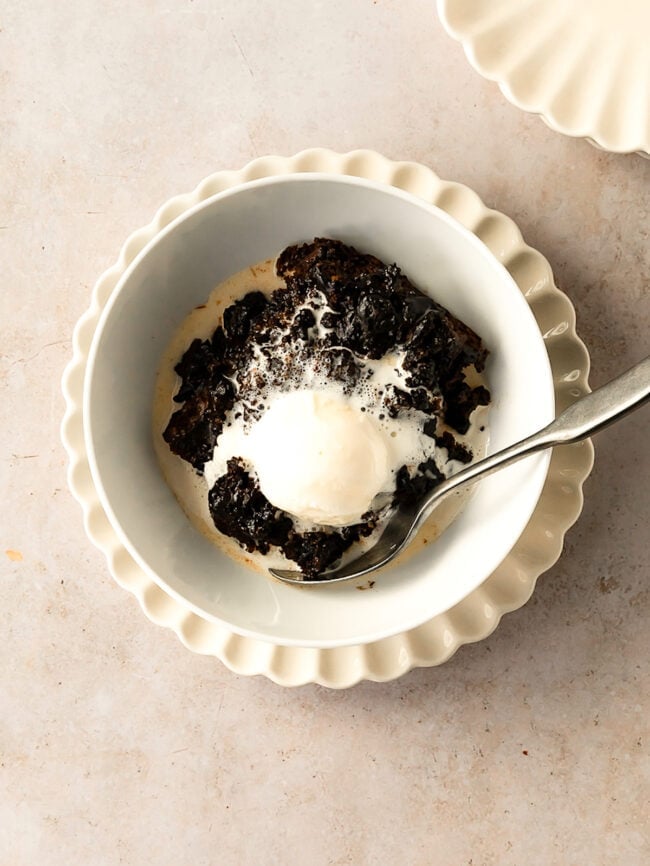 chocolate hot fudge pudding cake in bowl with ice cream