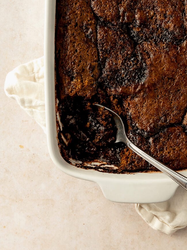 chocolate pudding cake in pan with spoon