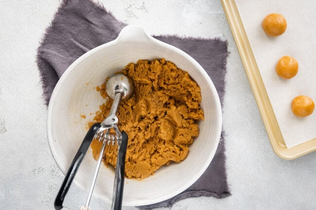 3 ingredient peanut butter cookie dough in bowl with cookie scoop