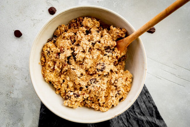 cowboy cookie dough in bowl with wooden spoon