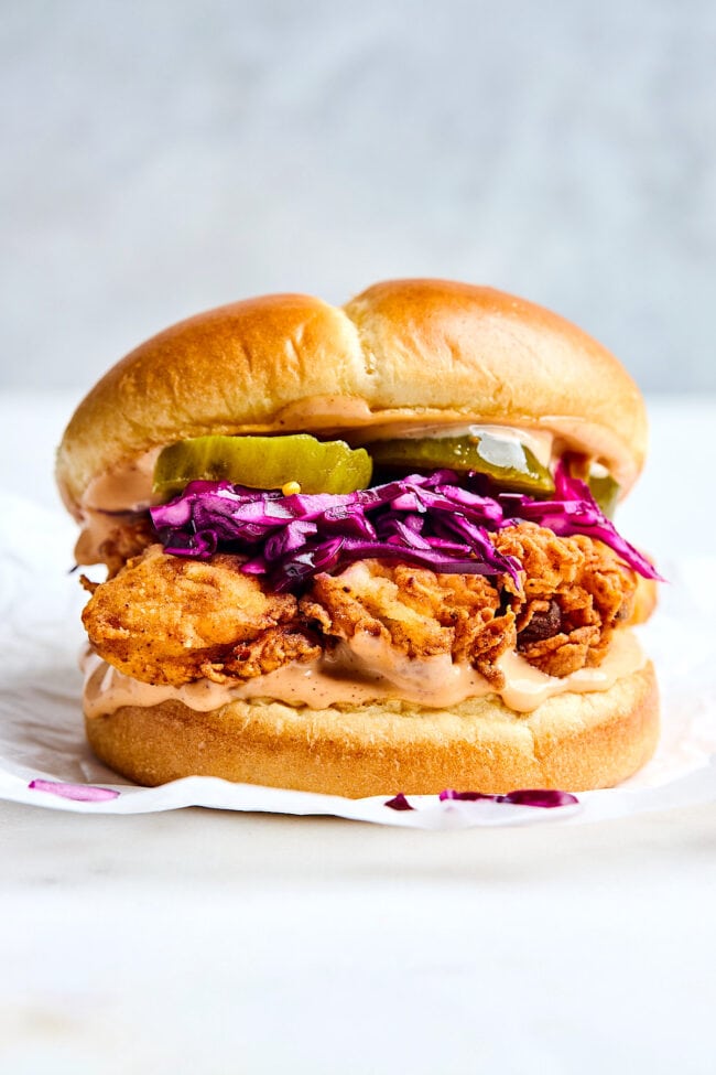 fried chicken sandwich with slaw pickles, special sauce on bun. 
