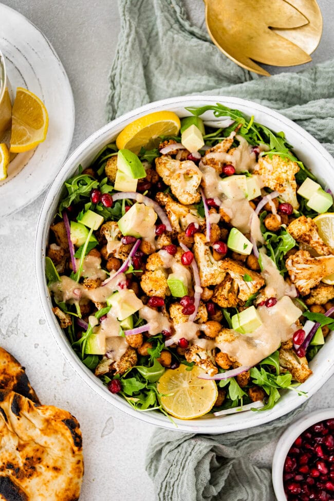 roasted cauliflower chickpea salad with tahini dressing in a bowl