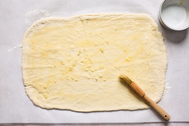 pizza dough rolled out in a rectangle for stromboli