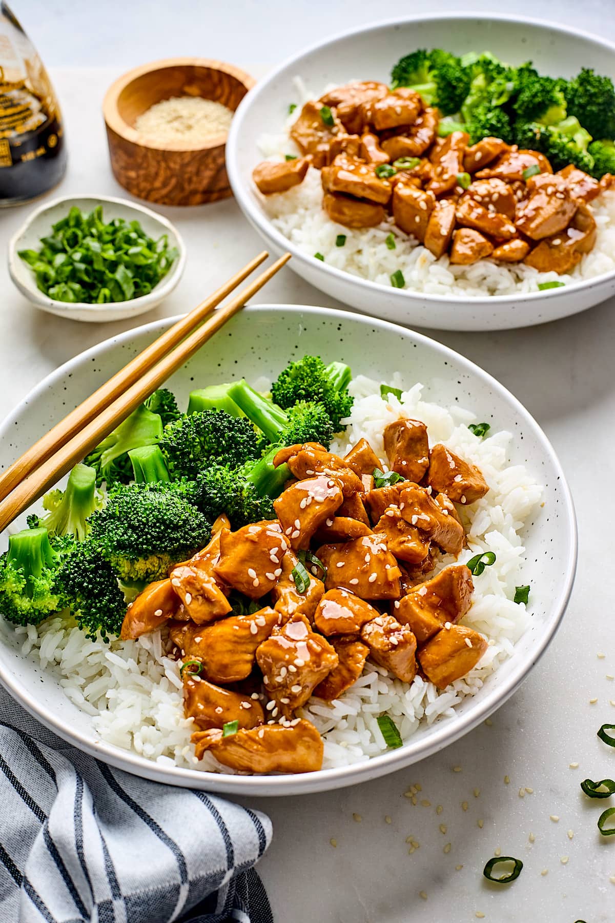 teriyaki chicken in bowls with rice and broccoli. 