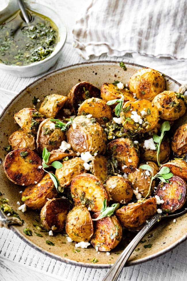 roasted potatoes with chimichurri sauce in bowl. 