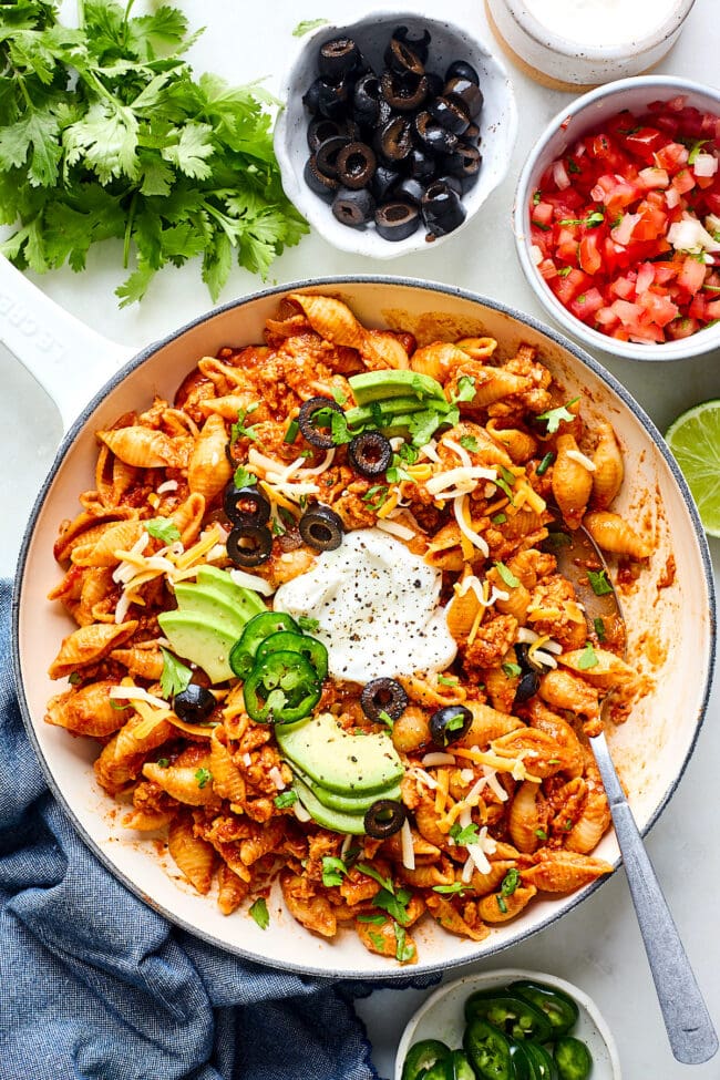 taco pasta in pan with toppings and spoon