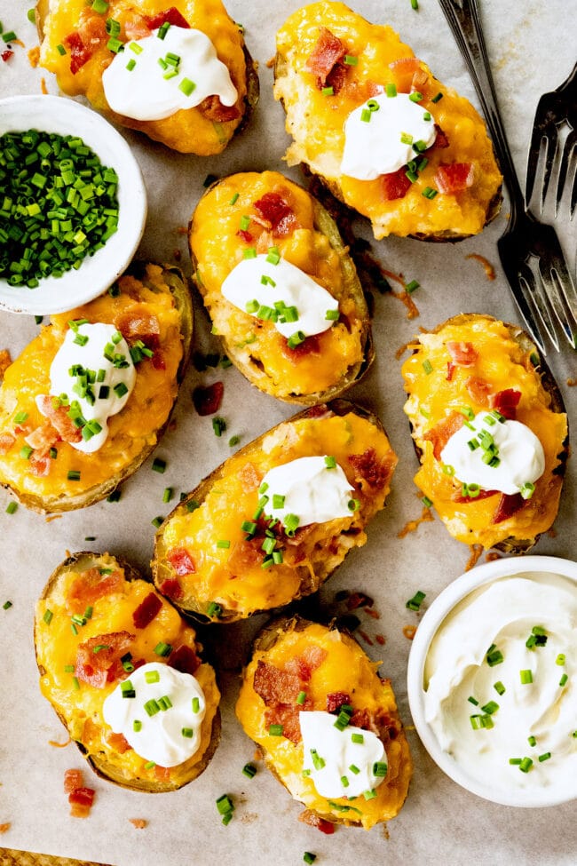 twice baked potatoes with cheese, bacon, sour cream, and chives