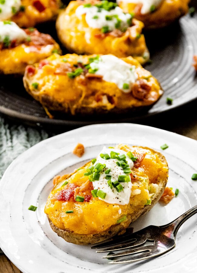 twice baked potato on plate with fork