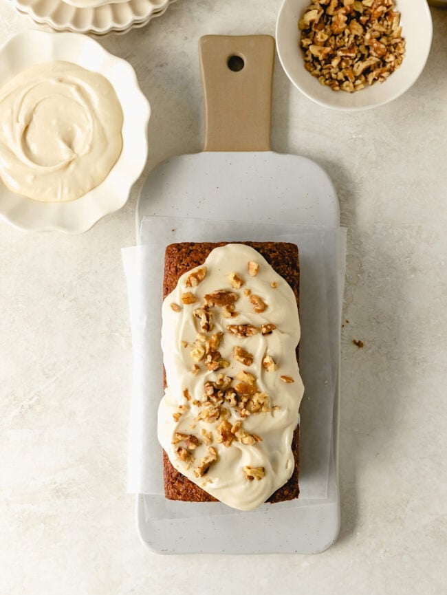 carrot cake loaf with cream cheese frosting and walnuts