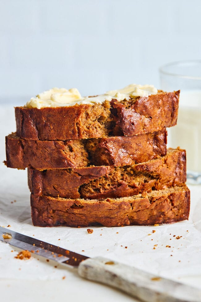 stack of banana bread slices with butter on top.