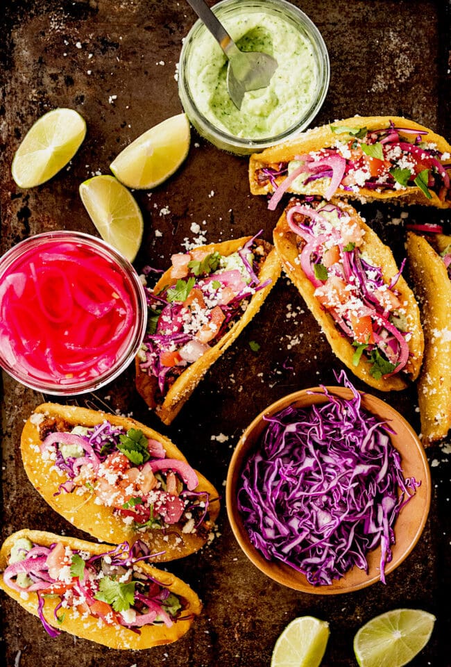 black bean tacos with pickled red onions, cabbage and avocado sauce