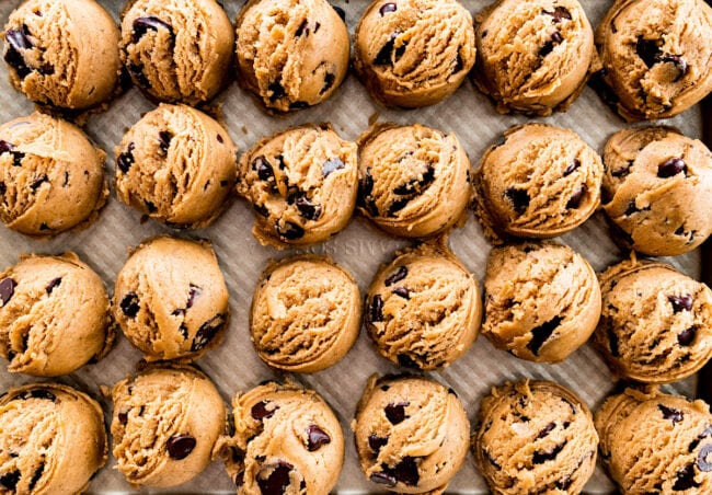 brown butter Biscoff chocolate chip cookie dough balls on baking sheet.