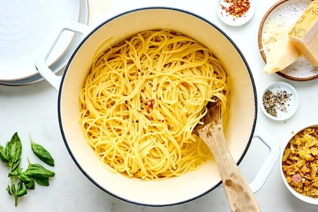 lemon spaghetti in pot with wooden spoon