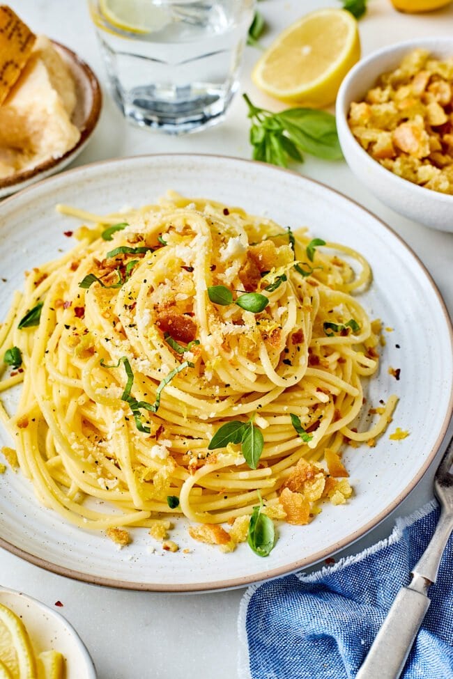 lemon spaghetti with garlic breadcrumbs, Parmesan cheese, and herbs on plate