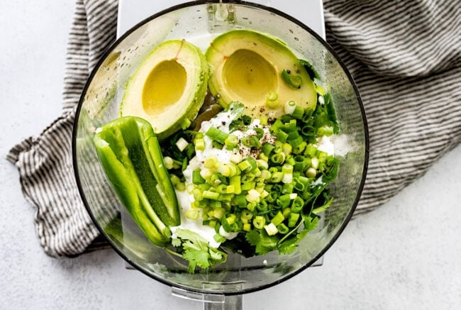 avocado sauce ingredients in food processor bowl