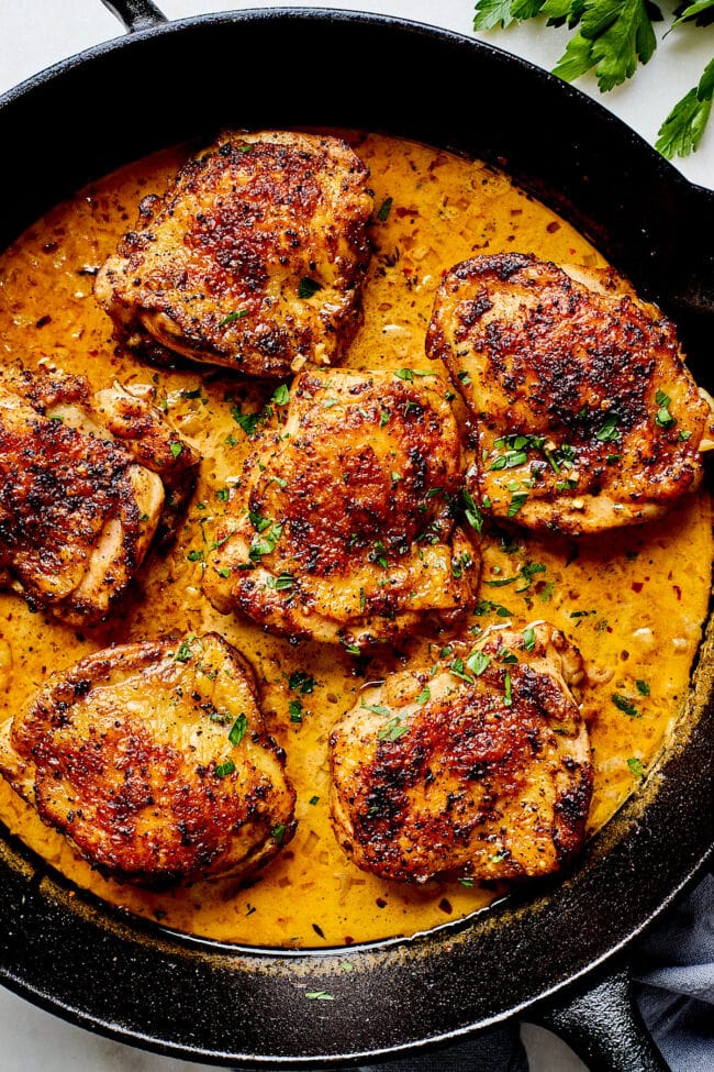 easy skillet chicken thighs in skillet with cream sauce. 