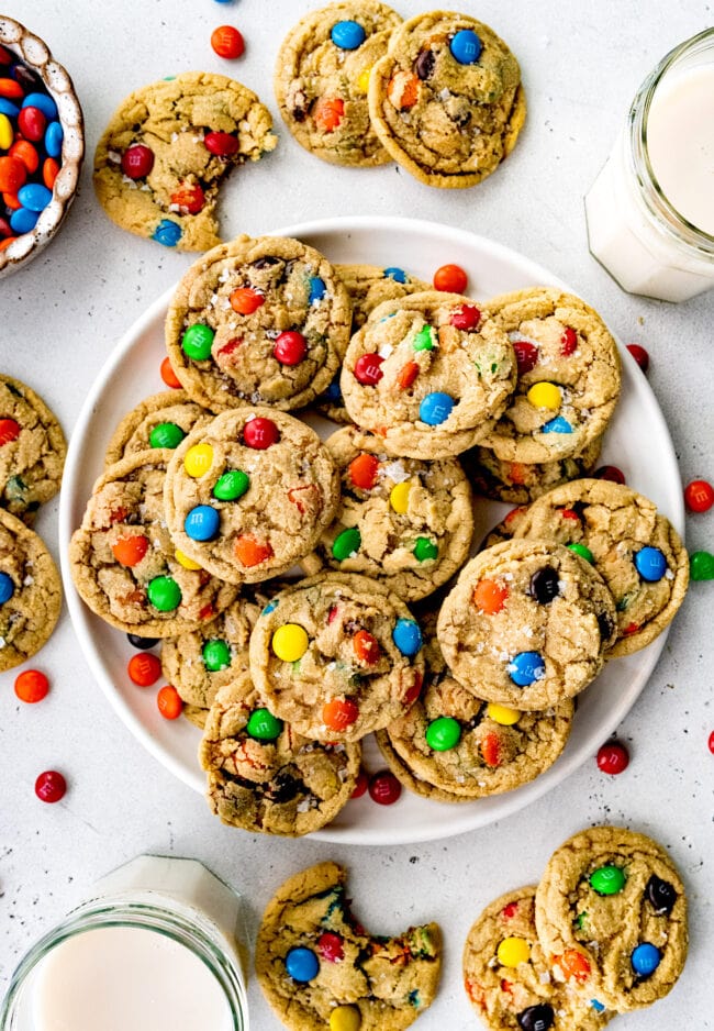 M&M cookies on plate with milk.
