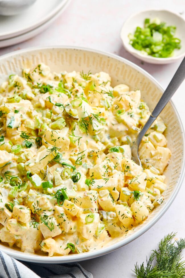 potato salad in bowl with spoon.