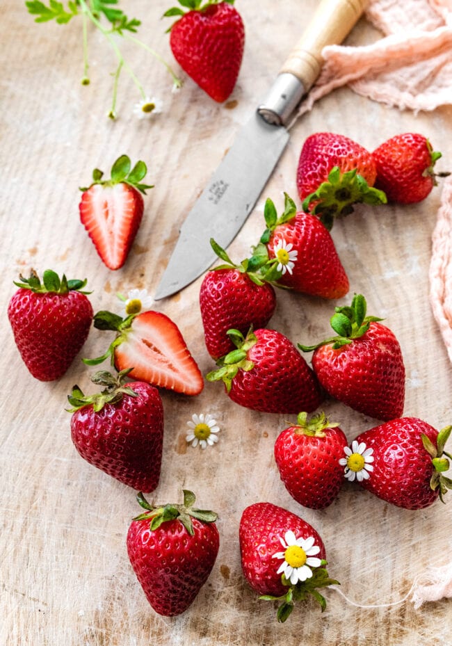 strawberries with a knife for strawberry muffins.