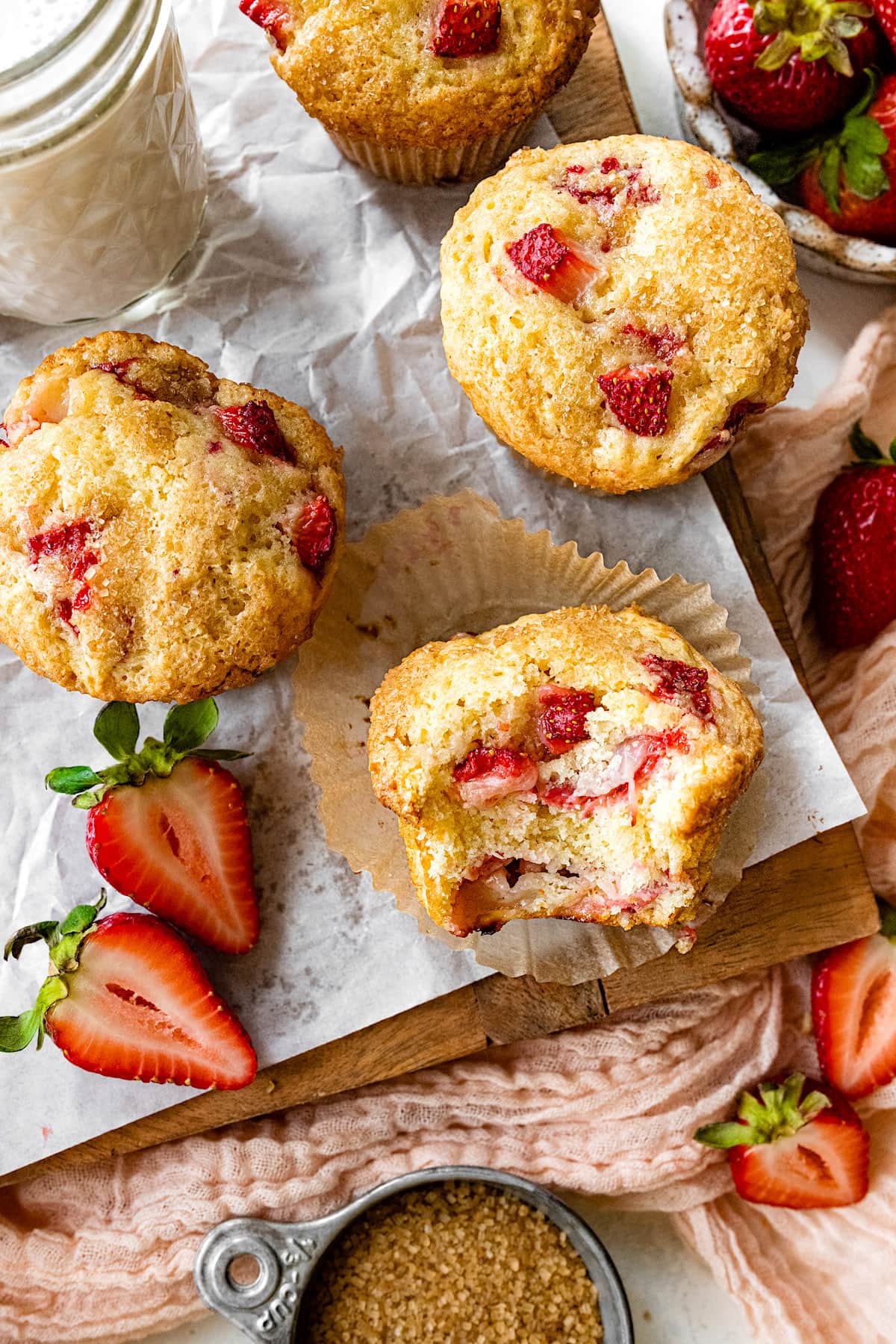fresh strawberry muffins on wood board with parchment paper. 