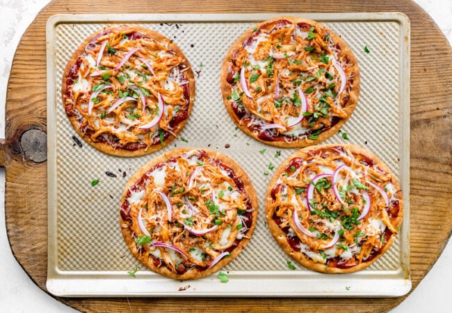 BBQ chicken pita pizzas on baking sheet. 