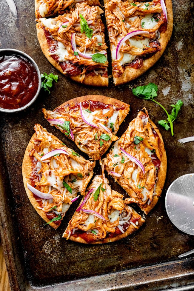 BBQ chicken pita pizzas on baking sheet. 