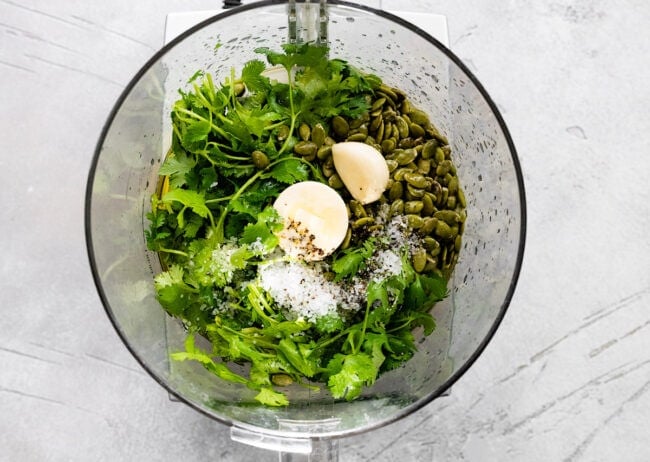 cilantro pesto ingredients in food processor.