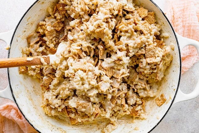 cinnamon toast crunch rice krispie treats in pot with spatula.