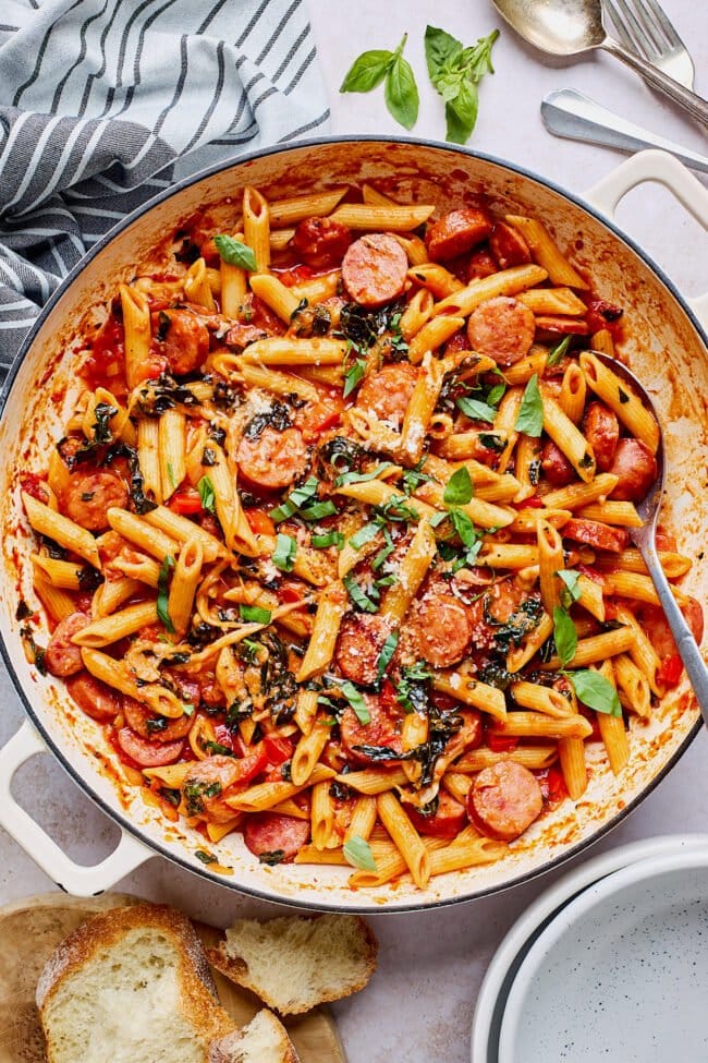 sausage pasta in pot with spoon.
