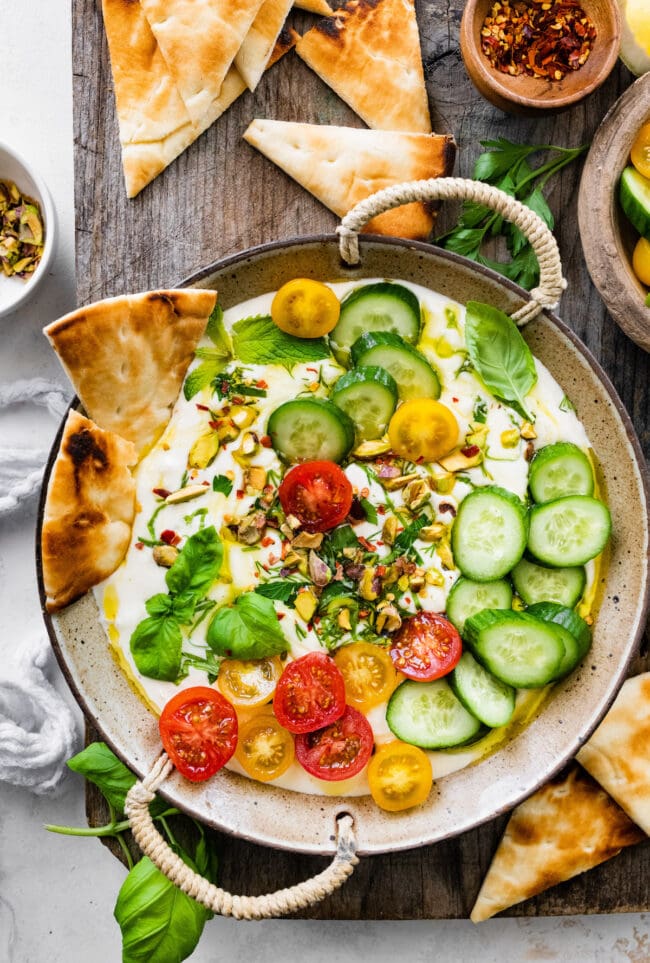 whipped feta with cucumbers, tomatoes, herbs, and pita bread.