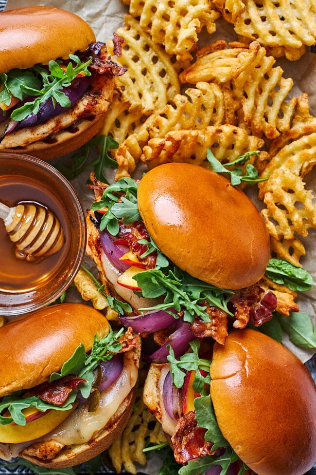 grilled chicken sandwiches with french fries. 