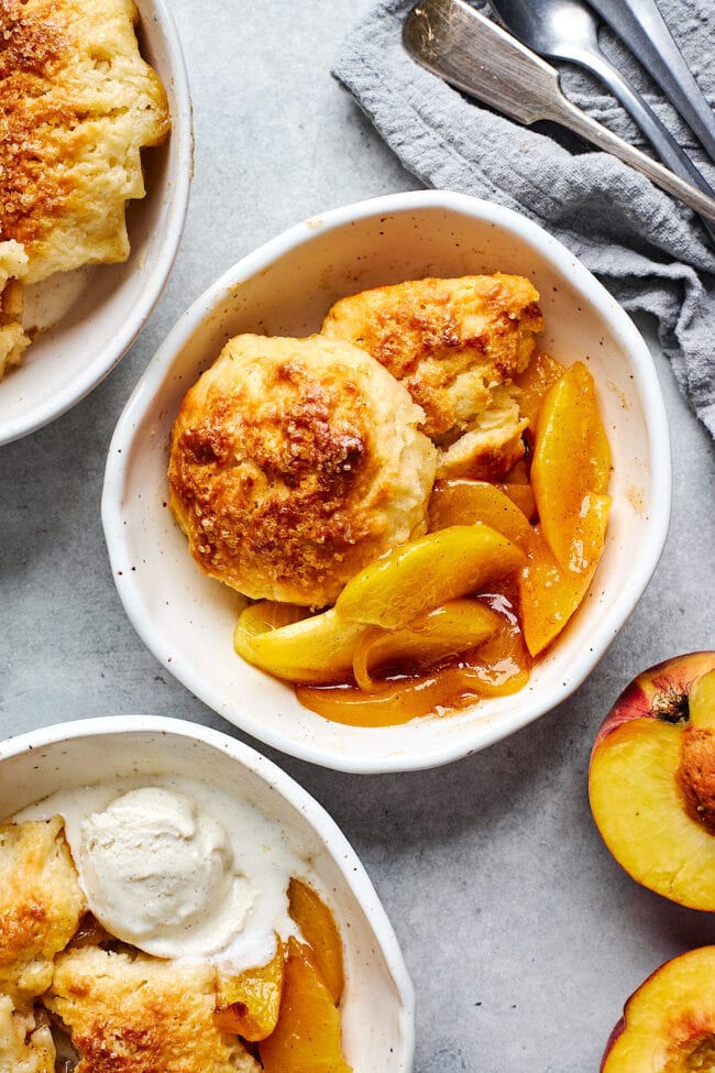 peach cobbler with biscuit topping in bowl. 