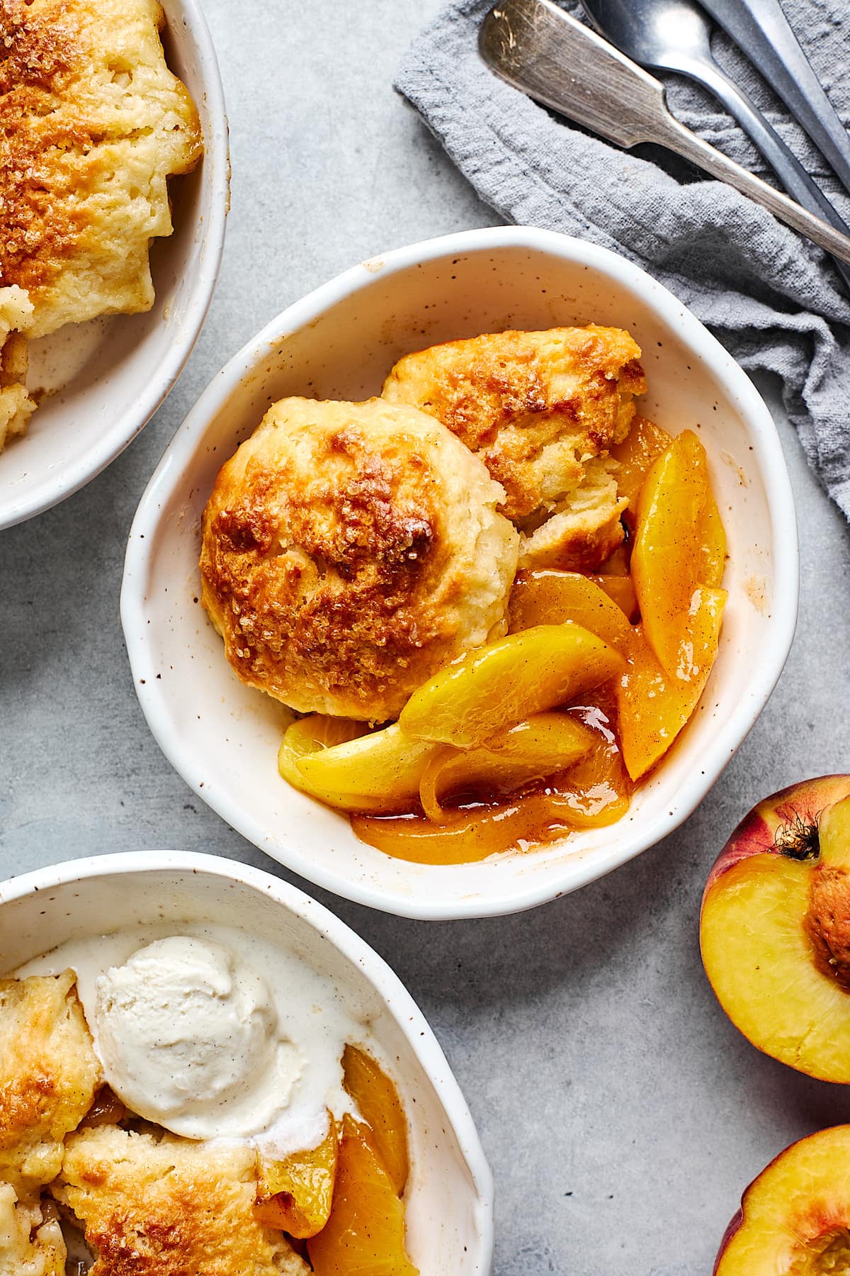 peach cobbler with biscuit topping in bowls. 