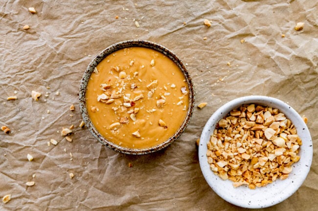 peanut sauce in bowl with fresh peanuts for spring rolls.