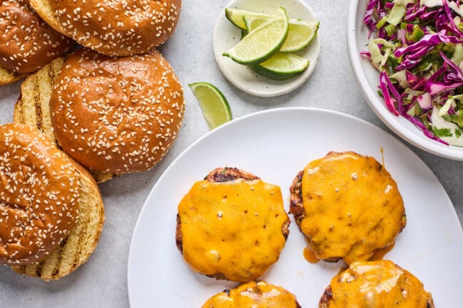 turkey burgers with cheese, hamburger buns, and slaw.