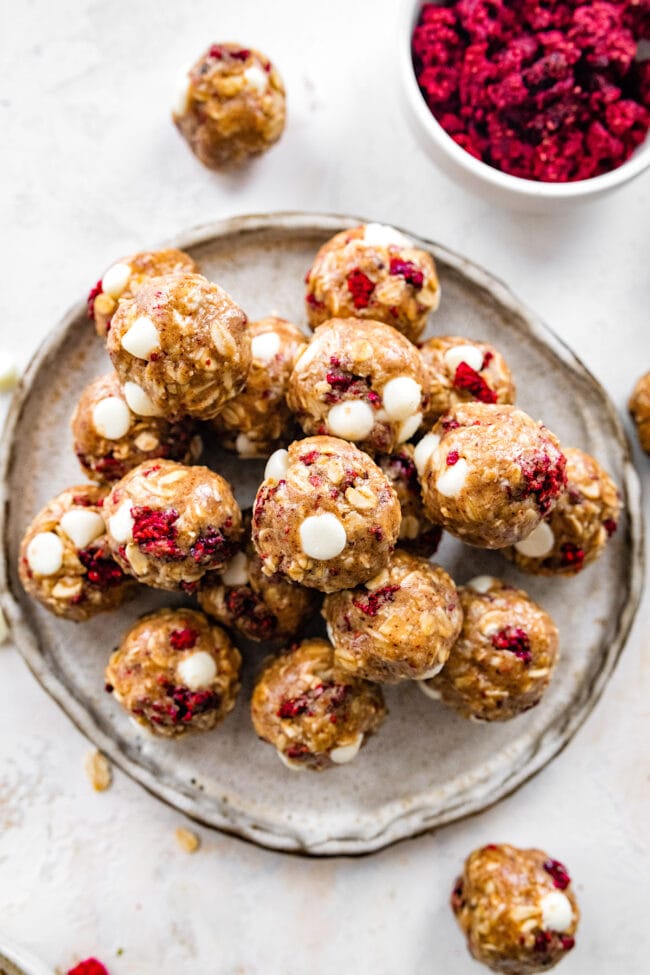 white chocolate raspberry energy balls on plate.