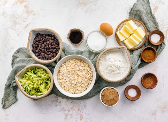 ingredients in bowls to make brown butter zucchini oatmeal chocolate chip cookies.